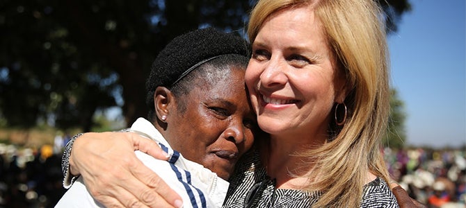 Ruth Todd Malawi 2016 Nu Skin Vice President of Public Affairs Ruth Todd embracing a Malawian mother